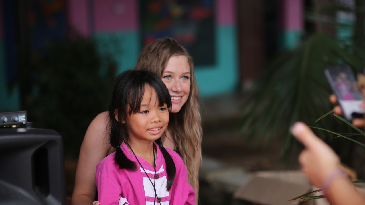 Mission team member with a girl during short-term Christian missions