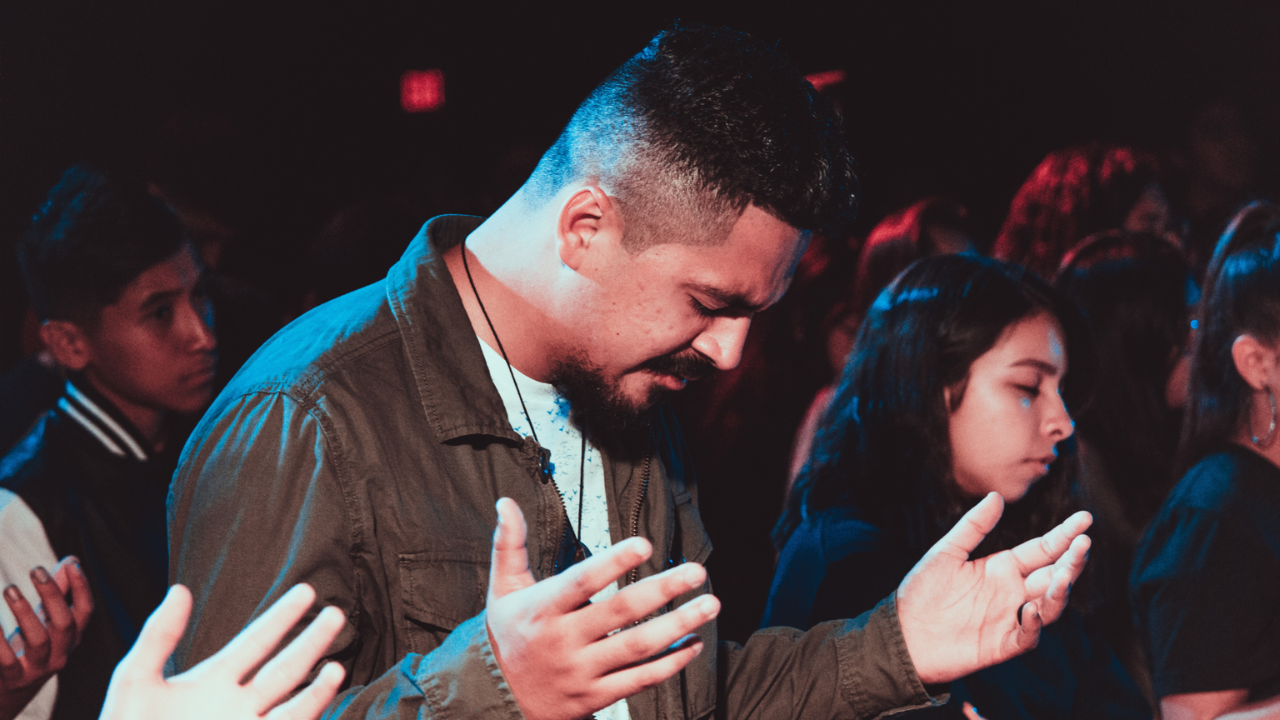 Man praying while discerning his Christian mission trip calling
