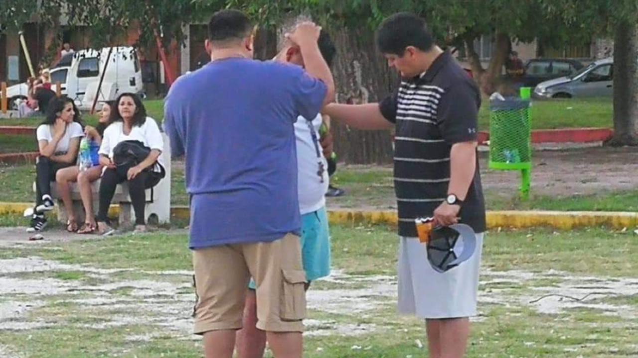 Small group praying together during Christian mission trip preparation