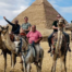 Christian mission trip team riding camels near the pyramids during an international ministry journey.