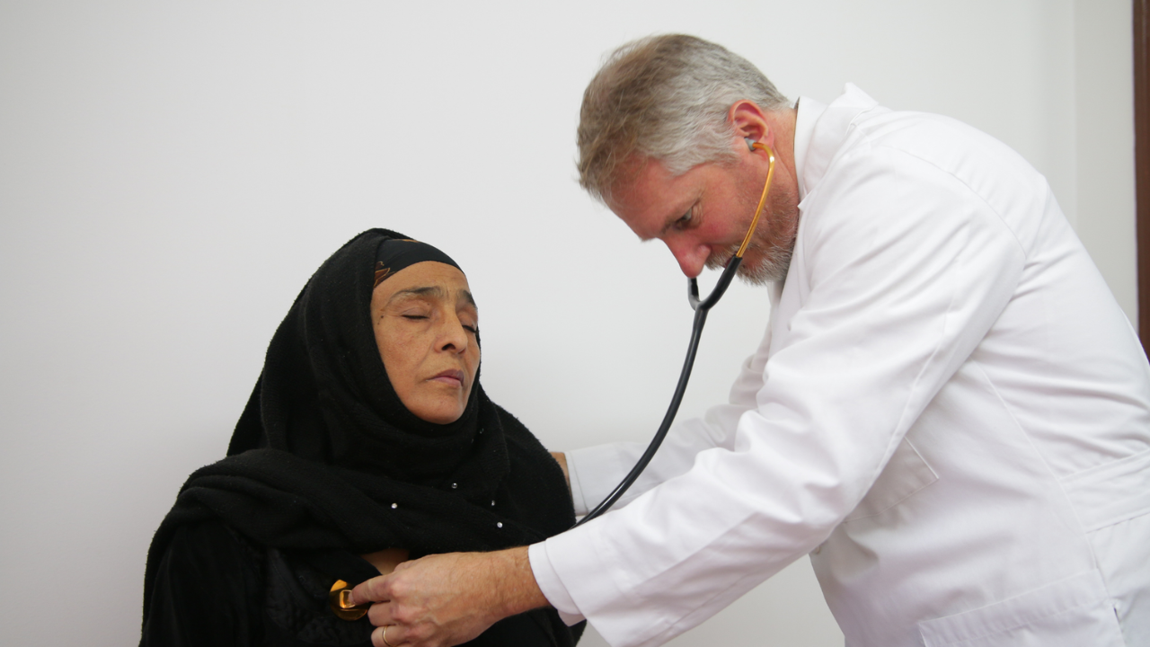 Doctor examining a local woman during a medical mission outreach.