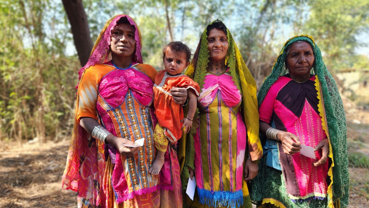 Women and a young child gathered during a community outreach in India.